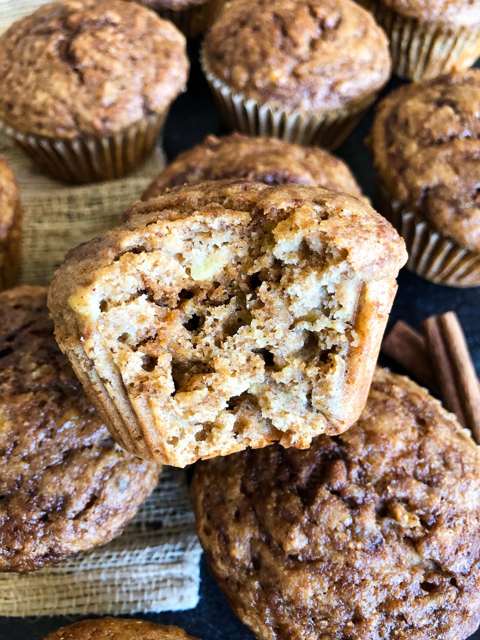 A photo of a bite taken out of banana muffins.