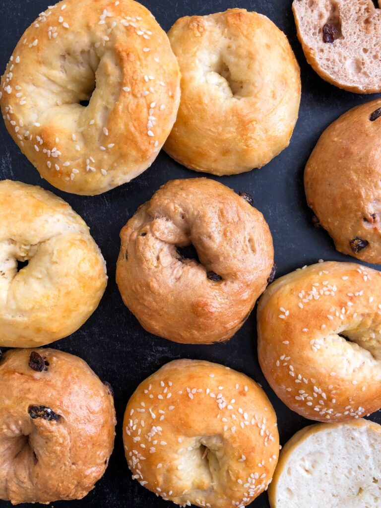 A lower-calorie, high protein bagel recipe, with 7 different flavor options. You'll crave these for breakfast every day! The flavors include: Cinnamon Raisin, Onion Sesame, Jalapeno Cheddar, Blueberry, Plain, Everything Bagel, and Poppy Seed.