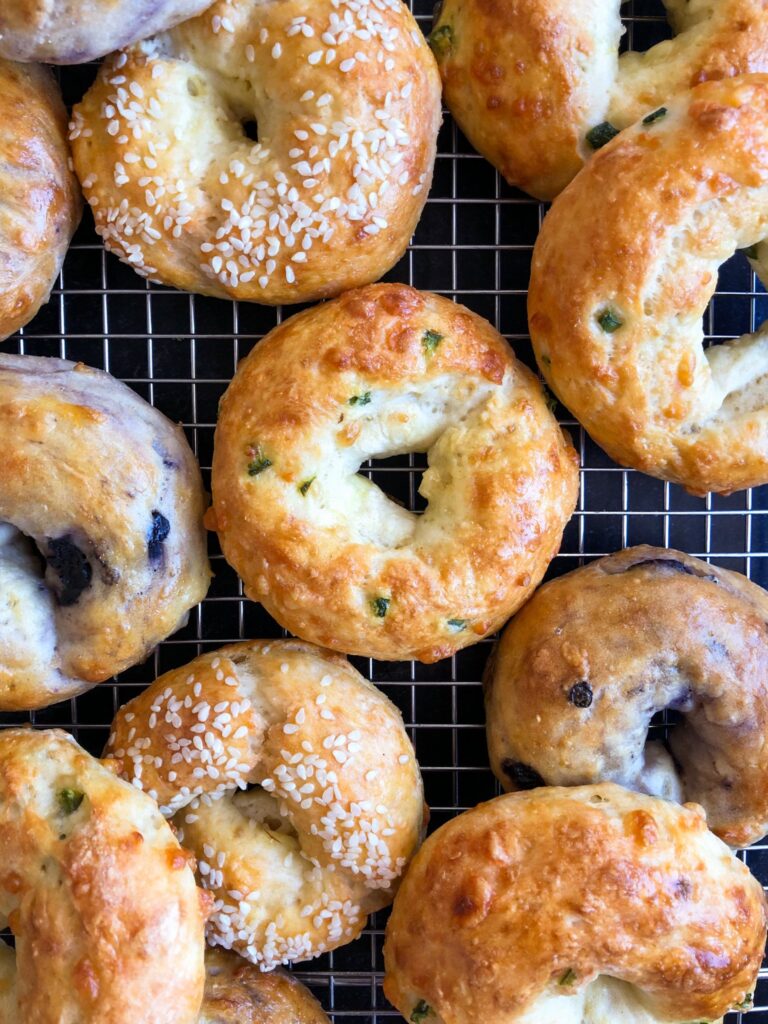 A lower-calorie, high protein bagel recipe, with 7 different flavor options. You'll crave these for breakfast every day! The flavors include: Cinnamon Raisin, Onion Sesame, Jalapeno Cheddar, Blueberry, Plain, Everything Bagel, and Poppy Seed.