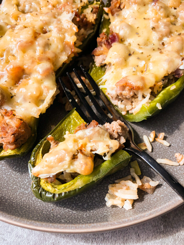 A bite taken out of stuffed poblano peppers. A representation of the cheesy yumminess it contains.