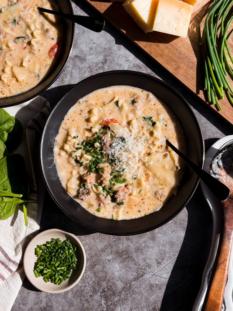 Overhead shot of White Lasagna Soup with moody sunlight lighting. This recipe is created by Christine Manes, owner of Home-Cooked Living (a healthy recipe website).