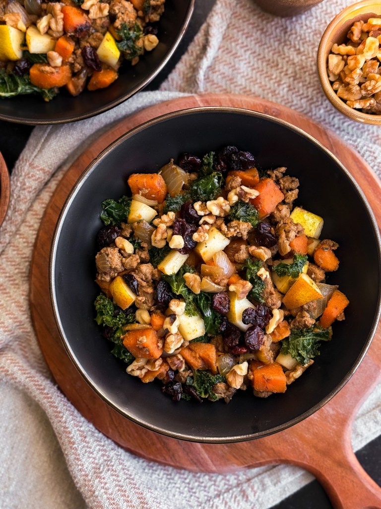 Top view of One-Pan Harvest Skillet that features sweet pear, tart cranberries (in dried craisin form), and crunchy walnuts. A recipe created by home-cooked living, a healthy recipe website.