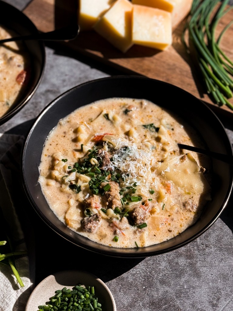 White Lasagna Soup topped with chives and fresh grated parmesan