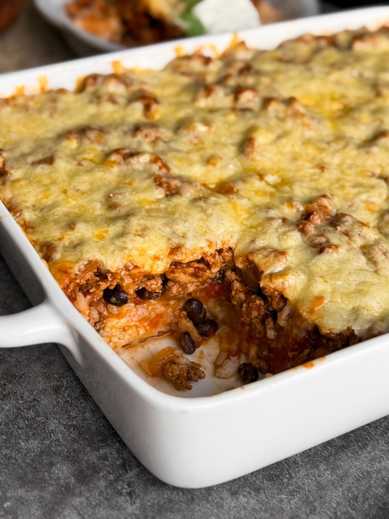 Healthy Taco Casserole - thick layers of rice, beans, taco meat, salsa, and cheese.