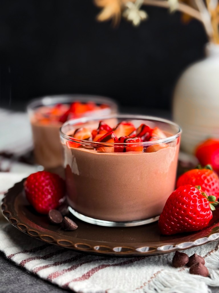 Photo of an easy chocolate cottage cheese pudding topped with diced strawberries and melted chocolate - Healthy Chocolate Protein Pudding.