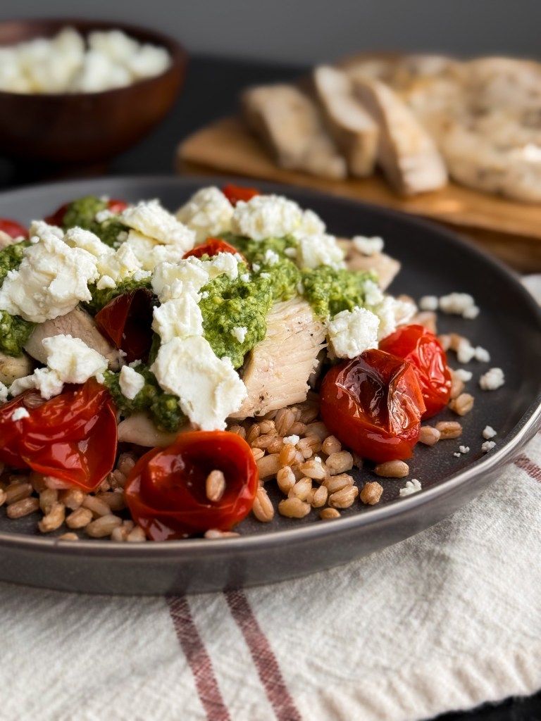 Pesto Chicken on a bed of Farro with Blistered Tomatoes and crumbled feta