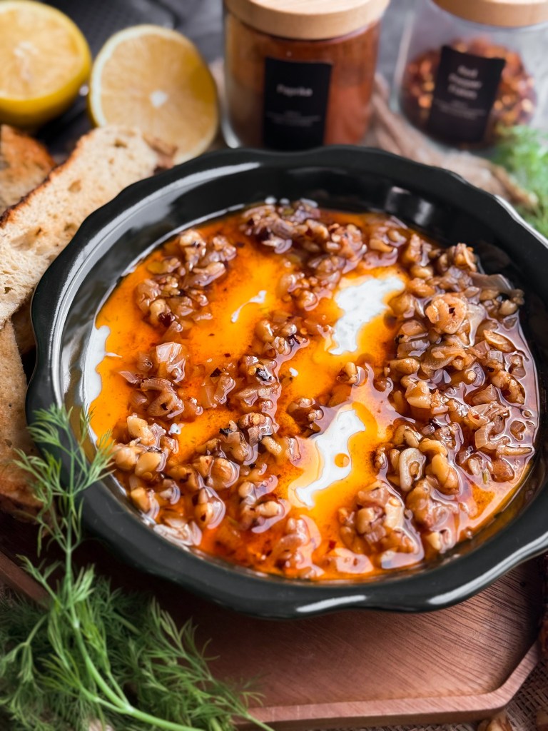 Zesty Yogurt Dip with a Chili Oil that has walnuts, shallots, garlic, and red pepper flakes. Then it's garnished with fresh dill and lemon zest, and served with toasted sourdough slices