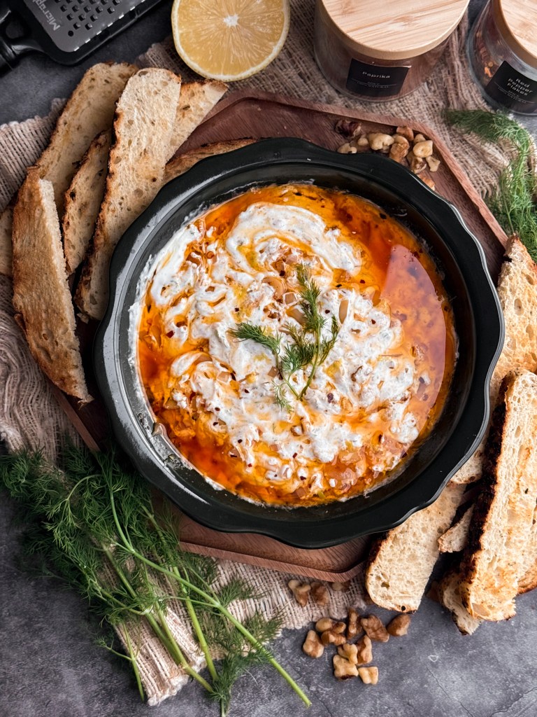Zesty Yogurt Dip with Chili Oil, garnished with fresh dill and lemon zest, and served with toasted sourdough slices