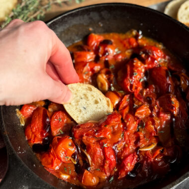 The easiest appetizer ever! Blistered tomatoes with toasted garlic, fresh thyme or basil, and a balsamic glaze goes perfectly with toasted sourdough, baguette, or crackers.