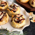 Healthy pastry recipe by home-cooked living. Filled with brie, rosemary, and jam, and topped with toasted almonds and balsamic glaze.