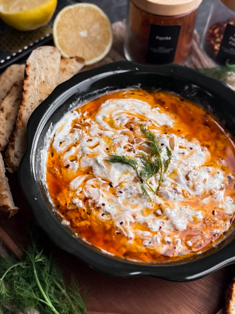 Zesty Yogurt Dip with a Chili Oil that has walnuts, shallots, garlic, and red pepper flakes. Then it's garnished with fresh dill and lemon zest, and served with toasted sourdough slices