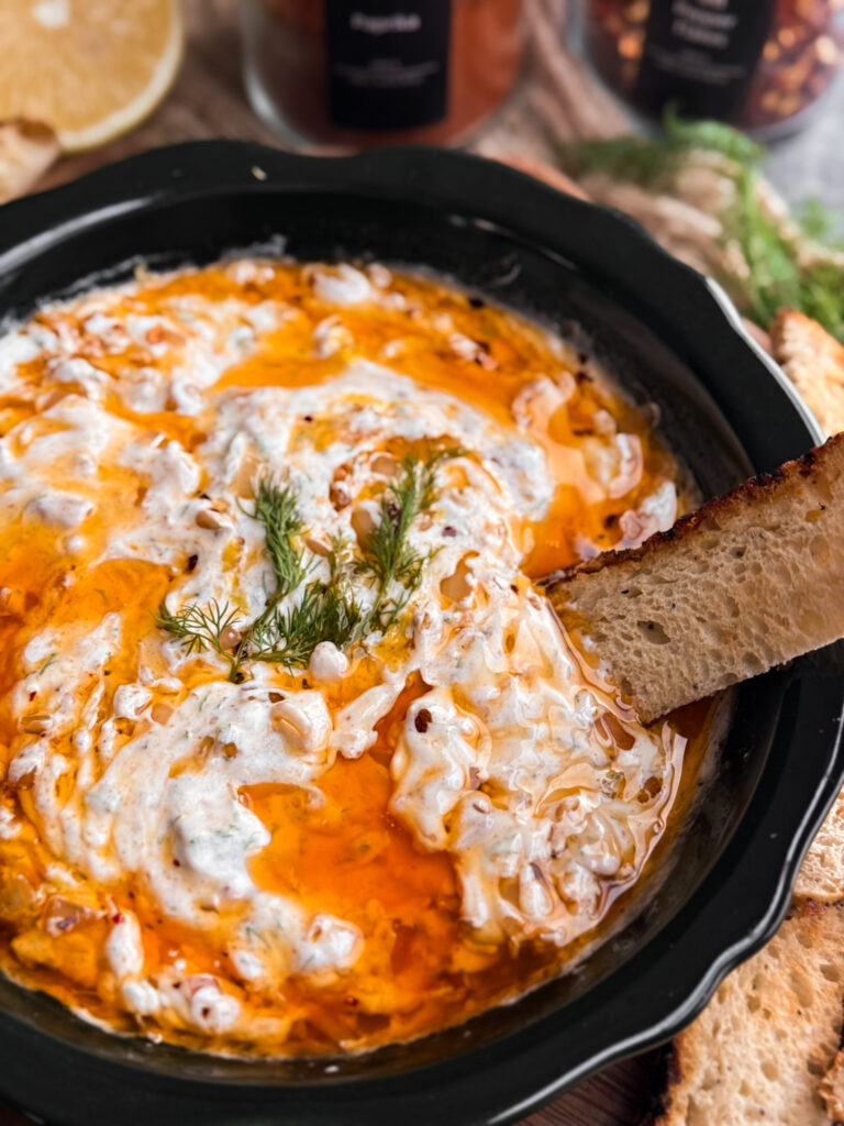 Zesty Yogurt Dip with a Chili Oil that has walnuts, shallots, garlic, and red pepper flakes. Then it's garnished with fresh dill and lemon zest, and served with toasted sourdough slices
