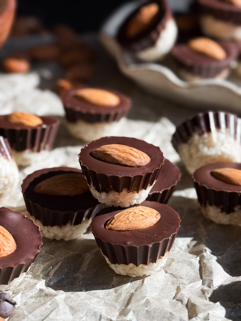 Homemade Almond Joys stacked on top of each other - aka Healthy Almond Joy Cups by Home-cooked living.