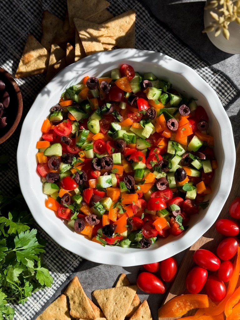 Loaded Hummus with cucumber, cherry tomatoes, bell pepper, Kalamata olives, and fresh parsley.